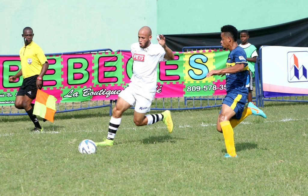 Luis Domingo Taveras del Moca  FC  intenta burlar un defensa del Pantoja